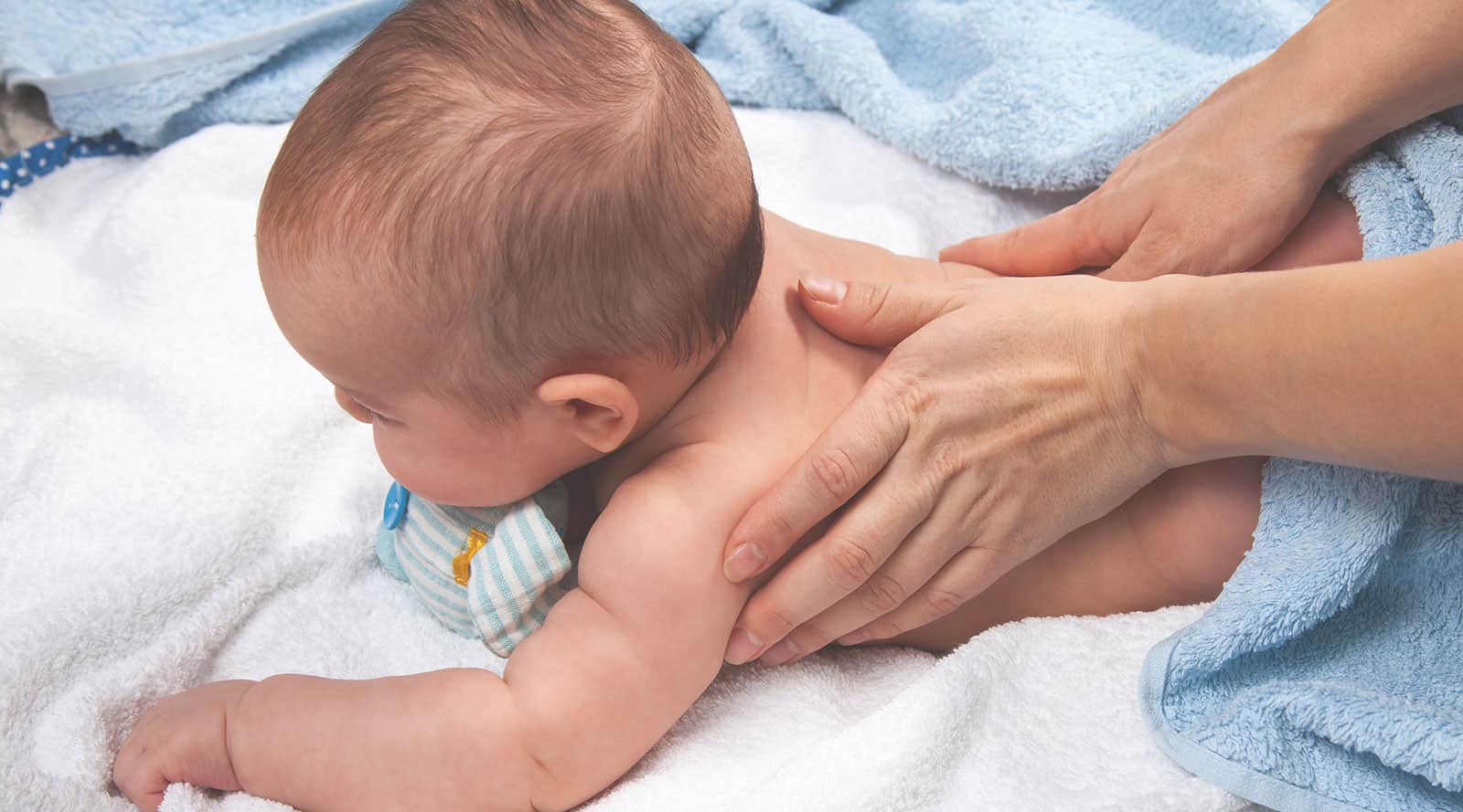 mother giving a baby massage