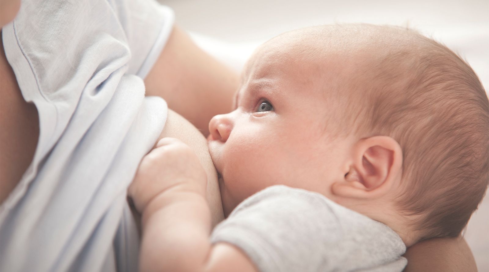 mother breastfeeding newborn baby